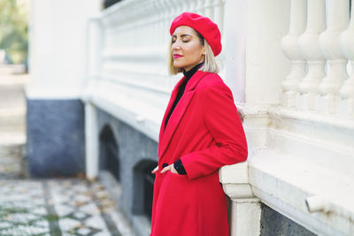 Side view of woman wearing red dress