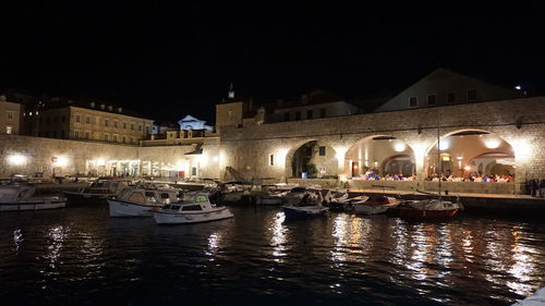 Boats in river at night