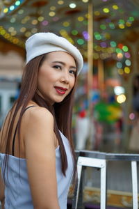 Portrait of beautiful woman looking standing in city