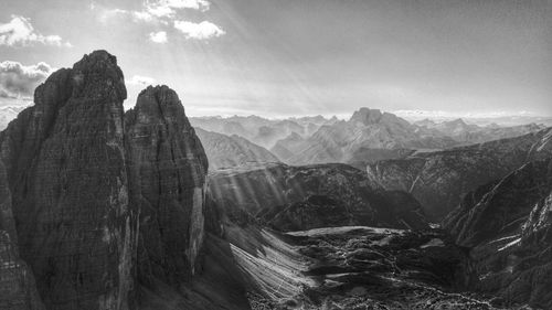 Scenic view of mountains against cloudy sky