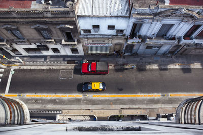 Directly above shot of cars parked on street amidst buildings