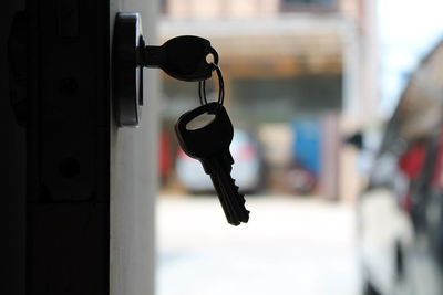 Close-up of key hanging on door