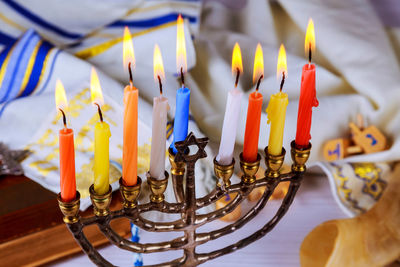 High angle view of colorful candles burning on table