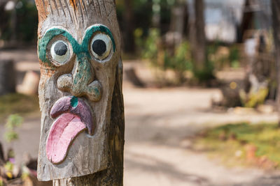 Close-up of statue against tree trunk