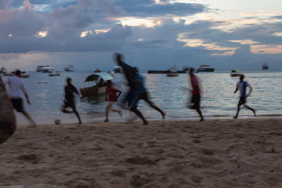 People on beach at sunset