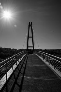 Footbridge over footpath against sky