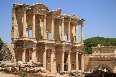 Low angle view of historical building against clear blue sky at ephesus turkey