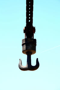 Low angle view of machine part against clear sky