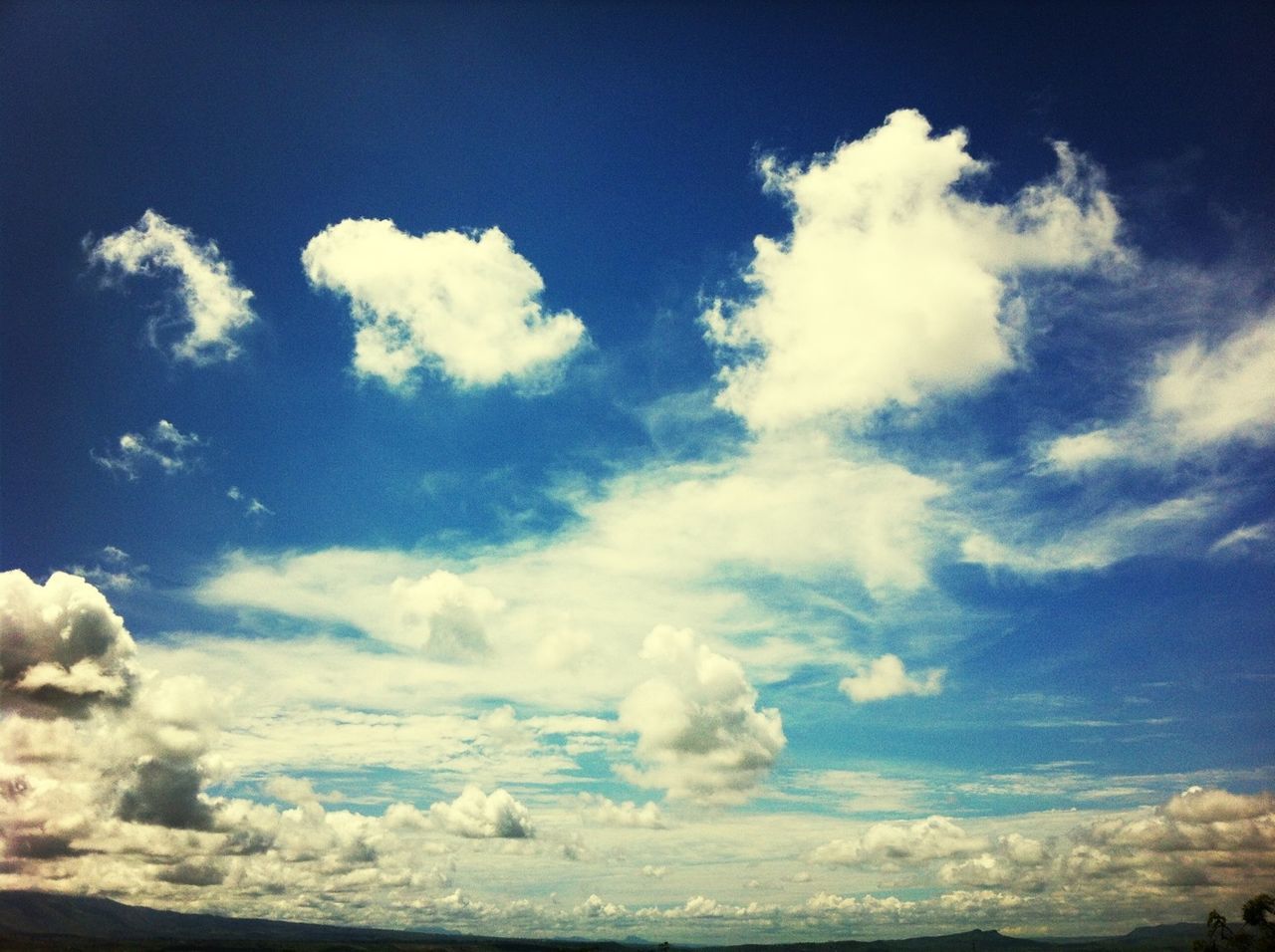 sky, tranquility, tranquil scene, beauty in nature, scenics, cloud - sky, nature, blue, white color, cloud, cloudy, cloudscape, low angle view, idyllic, day, white, outdoors, sky only, no people, majestic