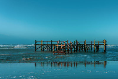 Pile dwelling on the norsee beach of sankt peter-ording in germany