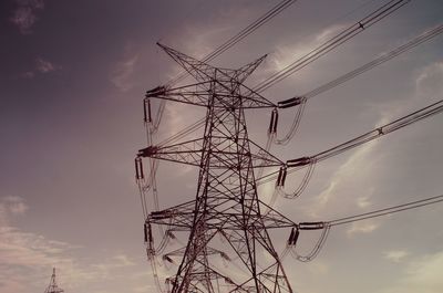 Low angle view of electricity pylon against sky