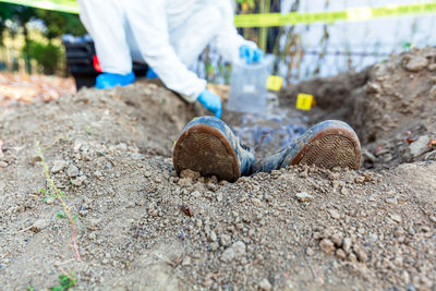 Forensic science specialist at work at a war crime scene investigation