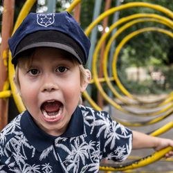 Portrait of boy with mouth open playing at jungle gym
