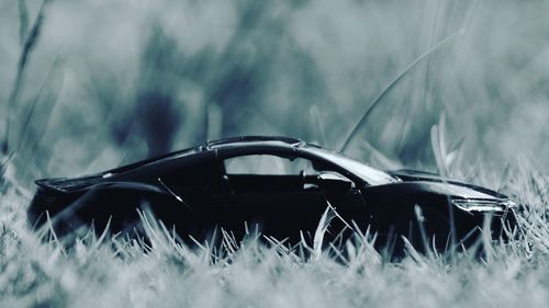 Close-up of black car on field
