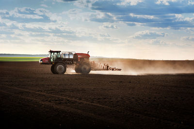 Tractor on field against sky