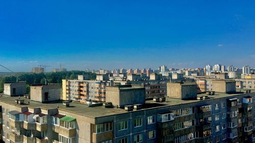 High angle view of buildings against blue sky