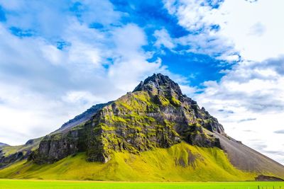 Scenic view of mountains against cloudy sky