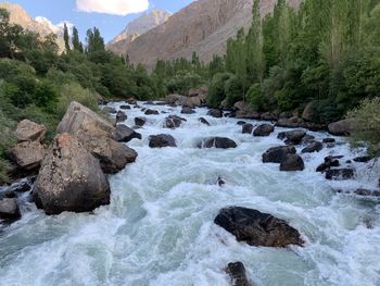 Scenic view of river flowing through rocks