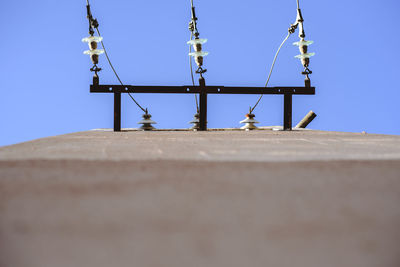 Low angle view of telephone pole against clear sky