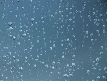 Full frame shot of raindrops on water