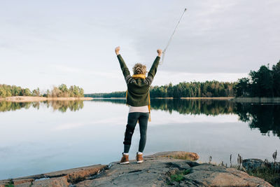 Injured woman celebrating walking by the coast in sweden