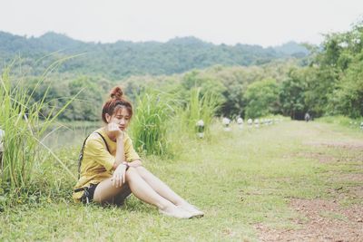 Woman sitting on field