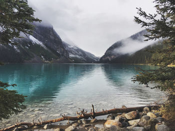 Scenic view of lake and mountains against sky