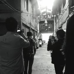 Rear view of man standing in front of building