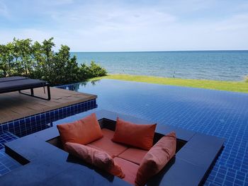 Scenic view of swimming pool by sea against sky