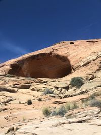 Scenic view of desert against clear blue sky