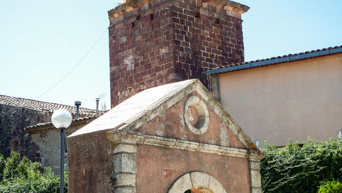 Low angle view of old abandoned building against sky