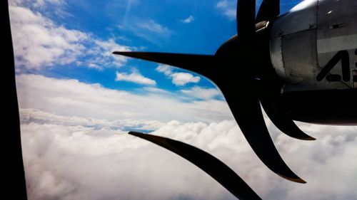 Close-up of airplane flying in sky