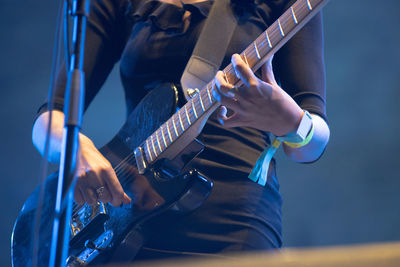 Woman playing guitar on stage