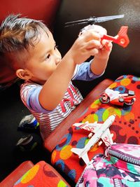 Boy playing with toy at home