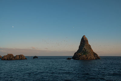 Scenic view of sea against clear sky during sunset