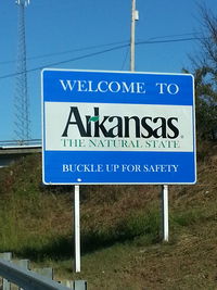 Close-up of signboard against blue sky