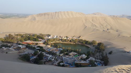 Scenic view of sand dunes against sky