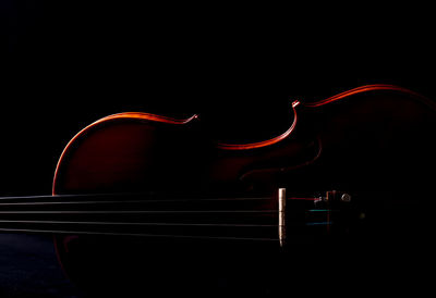 Close-up of guitar against black background