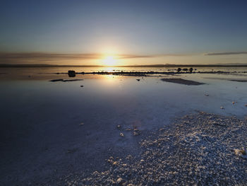 Sunset on the pink lagoon of the salt flats of torrevieja, spain