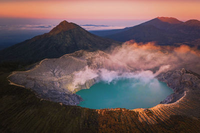 Panoramic view of volcanic mountain against sky during sunset