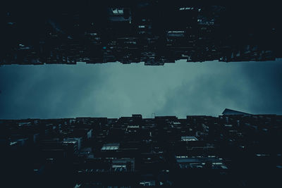 Low angle view of buildings against sky at night