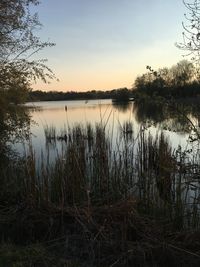 Scenic view of lake against sky during sunset