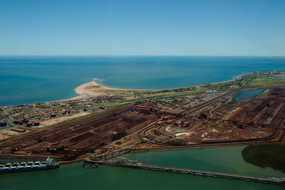 High angle view of road by sea against clear sky