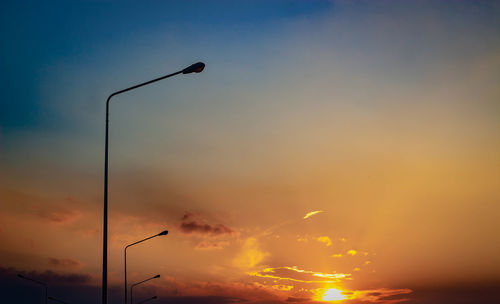 Low angle view of street light against sky during sunset