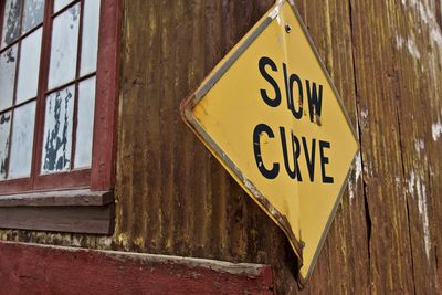 Close-up of arrow sign on wall