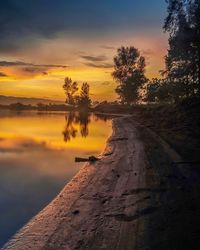 Scenic view of lake against sky during sunset