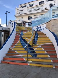 Graffiti on staircase of building in city