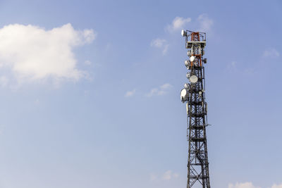 Low angle view of communications tower against sky