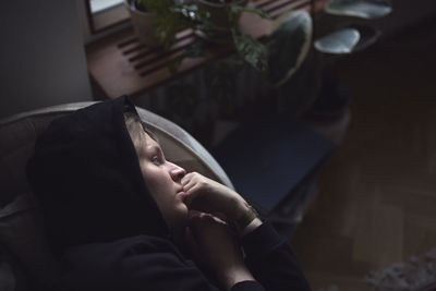 Sad man facing depression lying in bed