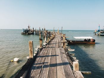 Pier over sea against clear sky